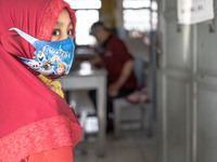 A little girl wait for her turn for the school test at Depok, West Java, Indonesia, on July 6, 2020.  The Education and Culture Ministry has...