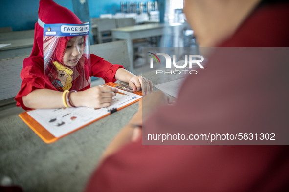 A little girl during her test for school selection test at Depok, West Java, Indonesia, on July 6, 2020.  The Education and Culture Ministry...