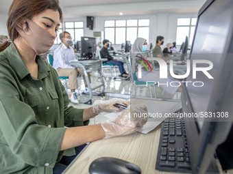 A woman participant waiting for the begin of the National Indonesia State Universtiy selection test at Universitas Pembangunan Nasional in D...