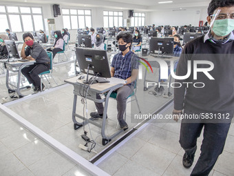 A supervisor at Campus Universitas Pembangunan National approach another supervisor in discussion for the test preparation during the Nation...