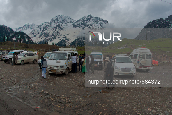 ZOJILA, INDIAN ADMINISTERED KASHMIR, INDIA - MAY 13: Indian tourists board and alight vehicles in sonmarg on the snow-cleared Srinagar-Leh h...