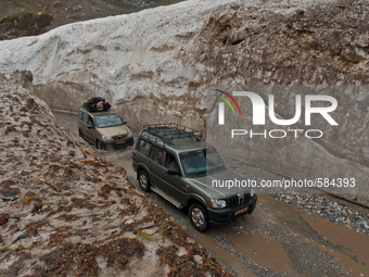 ZOJILA, INDIAN ADMINISTERED KASHMIR, INDIA - MAY 13: Vehicles pass through the snow-cleared Srinagar-Leh highway on a treacherous pass  afte...