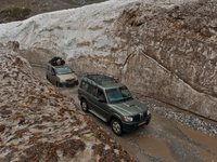 ZOJILA, INDIAN ADMINISTERED KASHMIR, INDIA - MAY 13: Vehicles pass through the snow-cleared Srinagar-Leh highway on a treacherous pass  afte...