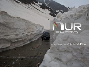 ZOJILA, INDIAN ADMINISTERED KASHMIR, INDIA - MAY 13: An Indian army vehicle passes through the snow-cleared Srinagar-Leh highway on a treach...