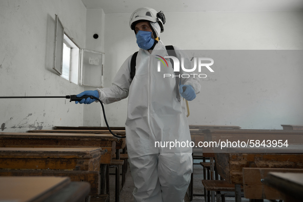 Members of civil defense known as white helmets sterilize school classes after discovering 3 COVID-19 cases in Idlib, Syria on July 11, 2020...