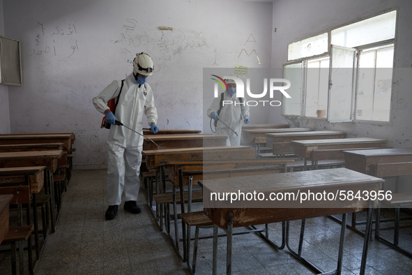 Members of civil defense known as white helmets sterilize school classes after discovering 3 COVID-19 cases in Idlib, Syria on July 11, 2020...