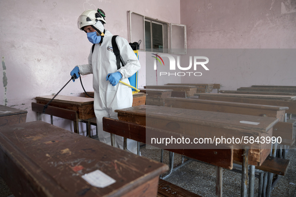 Members of civil defense known as white helmets sterilize school classes after discovering 3 COVID-19 cases in Idlib, Syria on July 11, 2020...