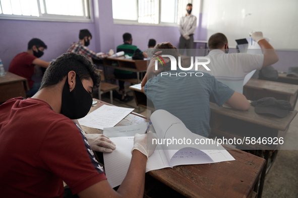 Syrian students in Idlib province take the middle school exam while maintaining safety procedures against the Coronavirus on July 12, 2020 