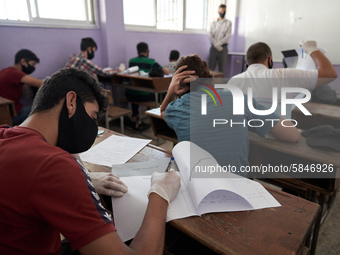 Syrian students in Idlib province take the middle school exam while maintaining safety procedures against the Coronavirus on July 12, 2020 (