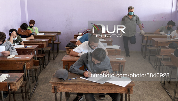 Syrian students in Idlib province take the middle school exam while maintaining safety procedures against the Coronavirus on July 12, 2020 