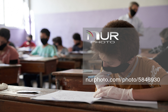 Syrian students in Idlib province take the middle school exam while maintaining safety procedures against the Coronavirus on July 12, 2020 