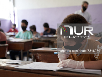 Syrian students in Idlib province take the middle school exam while maintaining safety procedures against the Coronavirus on July 12, 2020 (