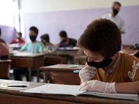 Syrian students in Idlib province take the middle school exam while maintaining safety procedures against the Coronavirus on July 12, 2020 (