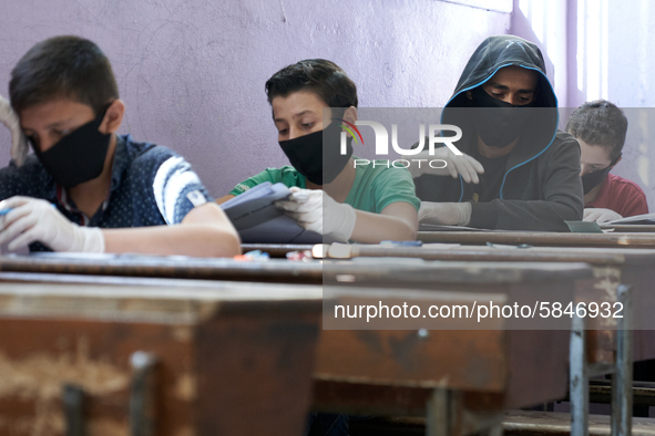 Syrian students in Idlib province take the middle school exam while maintaining safety procedures against the Coronavirus on July 12, 2020 