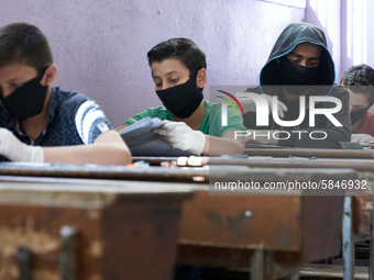 Syrian students in Idlib province take the middle school exam while maintaining safety procedures against the Coronavirus on July 12, 2020 (