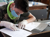 Syrian students in Idlib province take the middle school exam while maintaining safety procedures against the Coronavirus on July 12, 2020 (