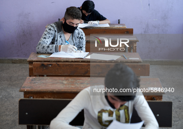 Syrian students in Idlib province take the middle school exam while maintaining safety procedures against the Coronavirus on July 12, 2020 