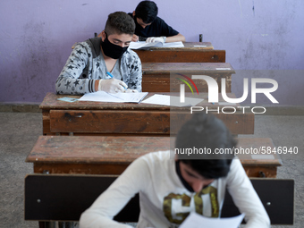 Syrian students in Idlib province take the middle school exam while maintaining safety procedures against the Coronavirus on July 12, 2020 (