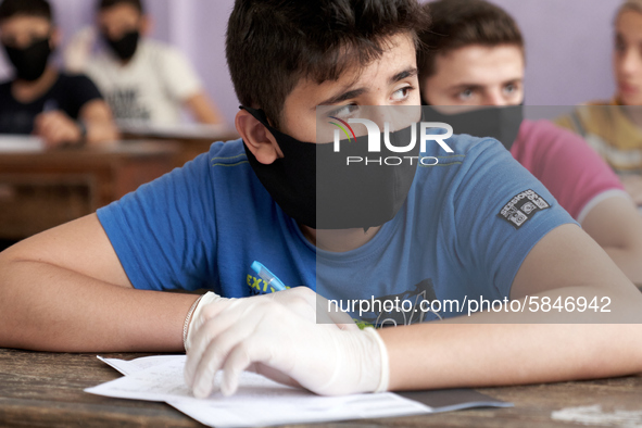 Syrian students in Idlib province take the middle school exam while maintaining safety procedures against the Coronavirus on July 12, 2020 