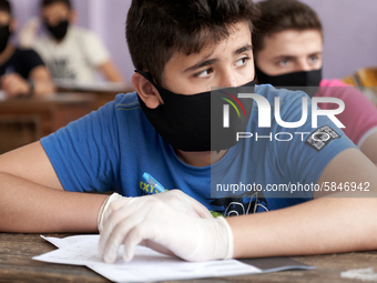 Syrian students in Idlib province take the middle school exam while maintaining safety procedures against the Coronavirus on July 12, 2020 (