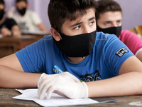 Syrian students in Idlib province take the middle school exam while maintaining safety procedures against the Coronavirus on July 12, 2020 (