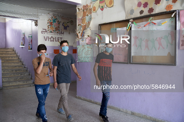 Syrian students in Idlib province take the middle school exam while maintaining safety procedures against the Coronavirus on July 12, 2020 