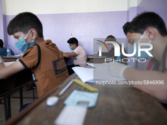 Syrian students in Idlib province take the middle school exam while maintaining safety procedures against the Coronavirus on July 12, 2020 (