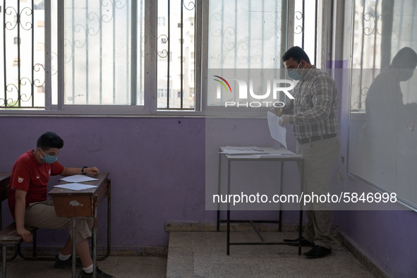 Syrian students in Idlib province take the middle school exam while maintaining safety procedures against the Coronavirus on July 12, 2020 