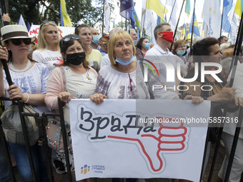 Ukrainians take part at a rally in support Ukrainian language and against a bill which offers to extend the use of the Russian language in U...