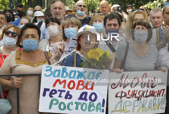 Ukrainians take part at a rally in support Ukrainian language and against a bill which offers to extend the use of the Russian language in U...