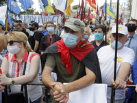 Ukrainians take part at a rally in support Ukrainian language and against a bill which offers to extend the use of the Russian language in U...