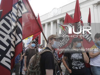 Ukrainians take part at a rally in support Ukrainian language and against a bill which offers to extend the use of the Russian language in U...