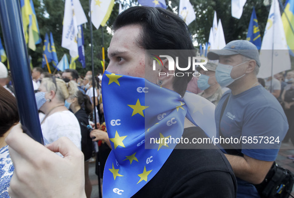 Ukrainians take part at a rally in support Ukrainian language and against a bill which offers to extend the use of the Russian language in U...