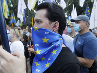 Ukrainians take part at a rally in support Ukrainian language and against a bill which offers to extend the use of the Russian language in U...