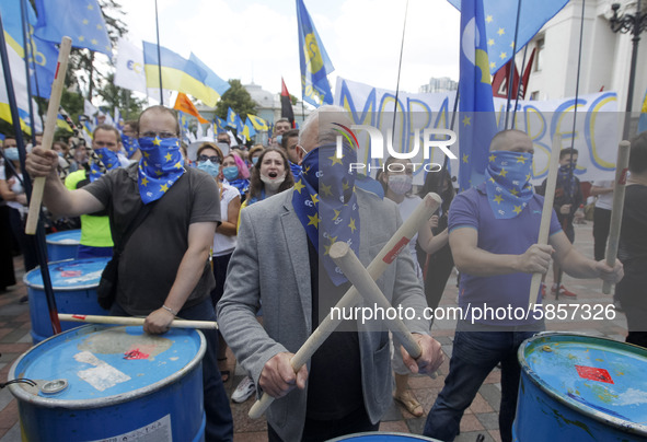 Ukrainians take part at a rally in support Ukrainian language and against a bill which offers to extend the use of the Russian language in U...