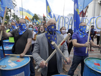 Ukrainians take part at a rally in support Ukrainian language and against a bill which offers to extend the use of the Russian language in U...