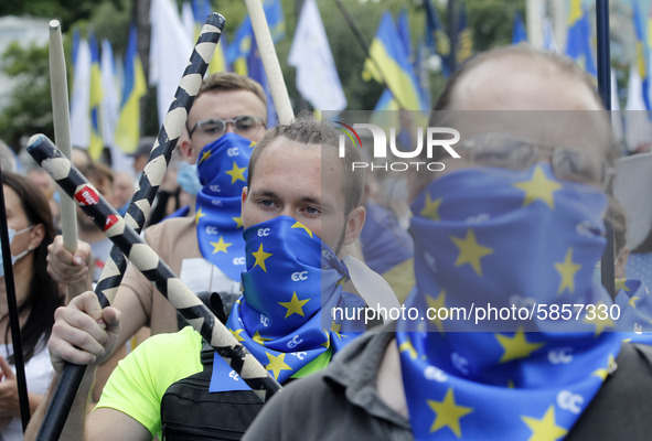 Ukrainians take part at a rally in support Ukrainian language and against a bill which offers to extend the use of the Russian language in U...