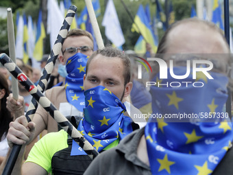 Ukrainians take part at a rally in support Ukrainian language and against a bill which offers to extend the use of the Russian language in U...