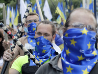 Ukrainians take part at a rally in support Ukrainian language and against a bill which offers to extend the use of the Russian language in U...