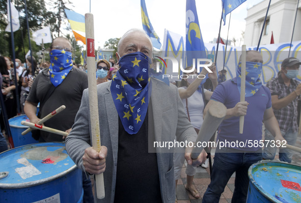 Ukrainians take part at a rally in support Ukrainian language and against a bill which offers to extend the use of the Russian language in U...