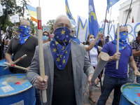 Ukrainians take part at a rally in support Ukrainian language and against a bill which offers to extend the use of the Russian language in U...