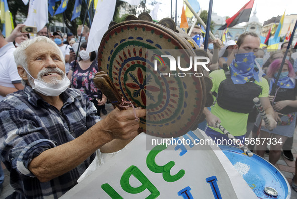 Ukrainians take part at a rally in support Ukrainian language and against a bill which offers to extend the use of the Russian language in U...