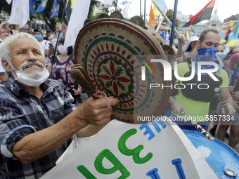 Ukrainians take part at a rally in support Ukrainian language and against a bill which offers to extend the use of the Russian language in U...