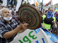 Ukrainians take part at a rally in support Ukrainian language and against a bill which offers to extend the use of the Russian language in U...