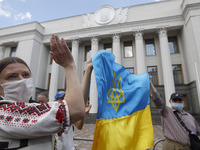 Ukrainians take part at a rally in support Ukrainian language and against a bill which offers to extend the use of the Russian language in U...