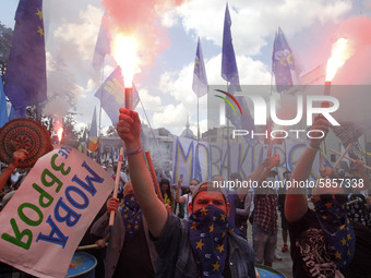 Ukrainians burn flares during a rally in support Ukrainian language and against a bill which offers to extend the use of the Russian languag...