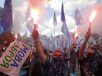 Ukrainians burn flares during a rally in support Ukrainian language and against a bill which offers to extend the use of the Russian languag...