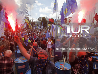 Ukrainians burn flares during a rally in support Ukrainian language and against a bill which offers to extend the use of the Russian languag...