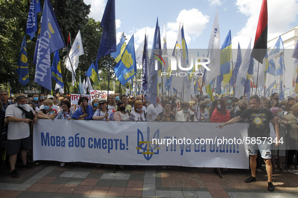 Ukrainians hold a banner reading like 'The language or death!' during a rally in support Ukrainian language and against a bill which offers...