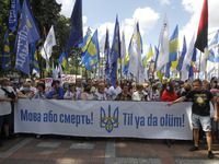 Ukrainians hold a banner reading like 'The language or death!' during a rally in support Ukrainian language and against a bill which offers...